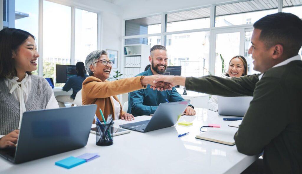 Business meeting in a conference room with people shaking hands