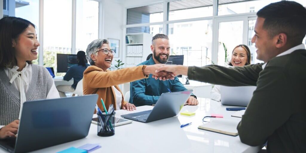 Business meeting in a conference room with people shaking hands